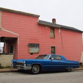 blue caddy by the pink house