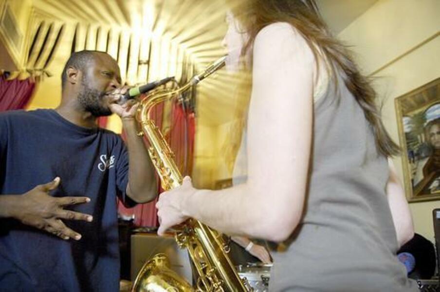 The Baltimore Sun Arts & Theater Cover Story, A VOICE OF VERSATILITY: Written by Sam Sessa. Shodekeh rocking with Saxophonist Tiffany DeFoe @ Dionysus. Photo by Christopher T. Assaf. October 7th, 2007. 