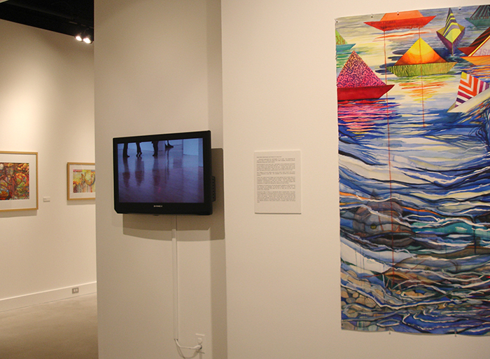The video, Reflection, is placed in the gallery among Diana Marta's paintings at Towson University in June of 2014