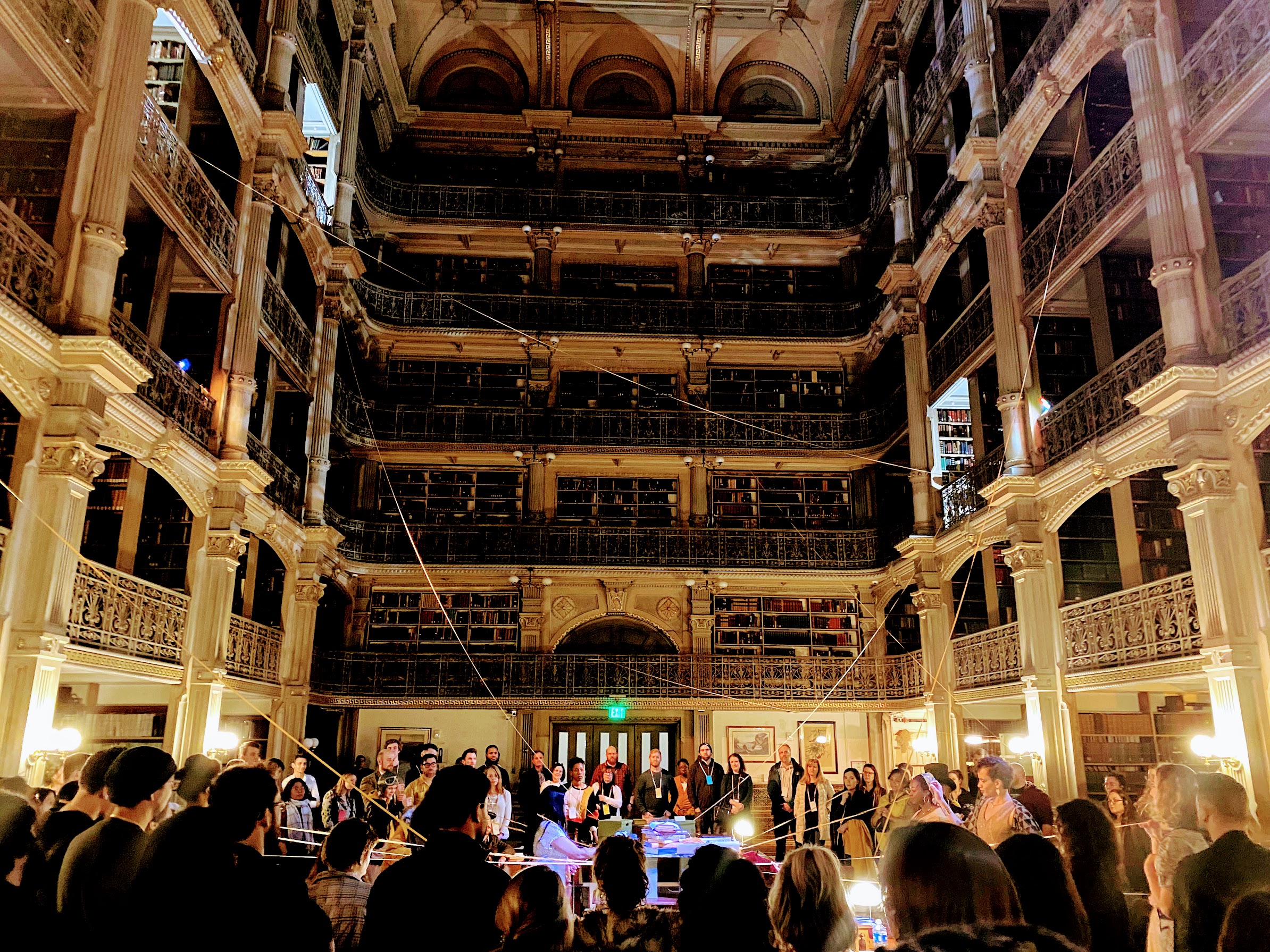 The culminating scene of See Also at the George Peabody Library with audience and cast members
