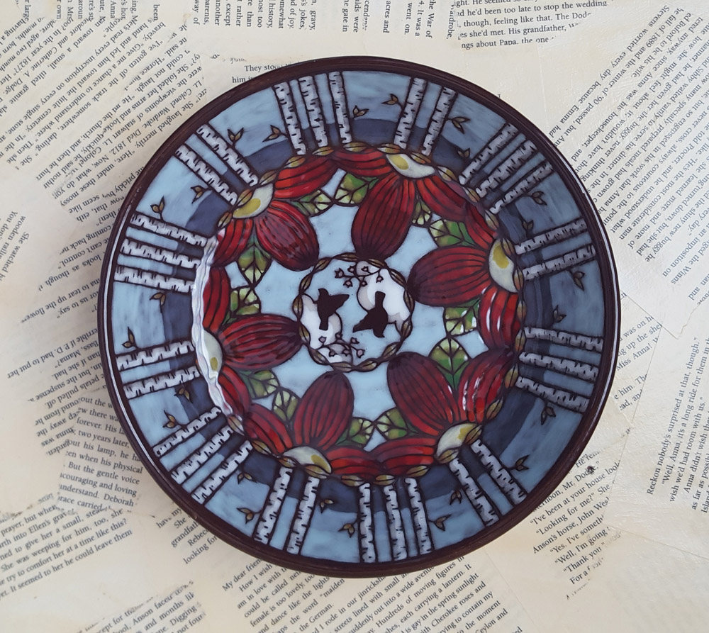 Bowl with painted birch trees, birds, and red flowers