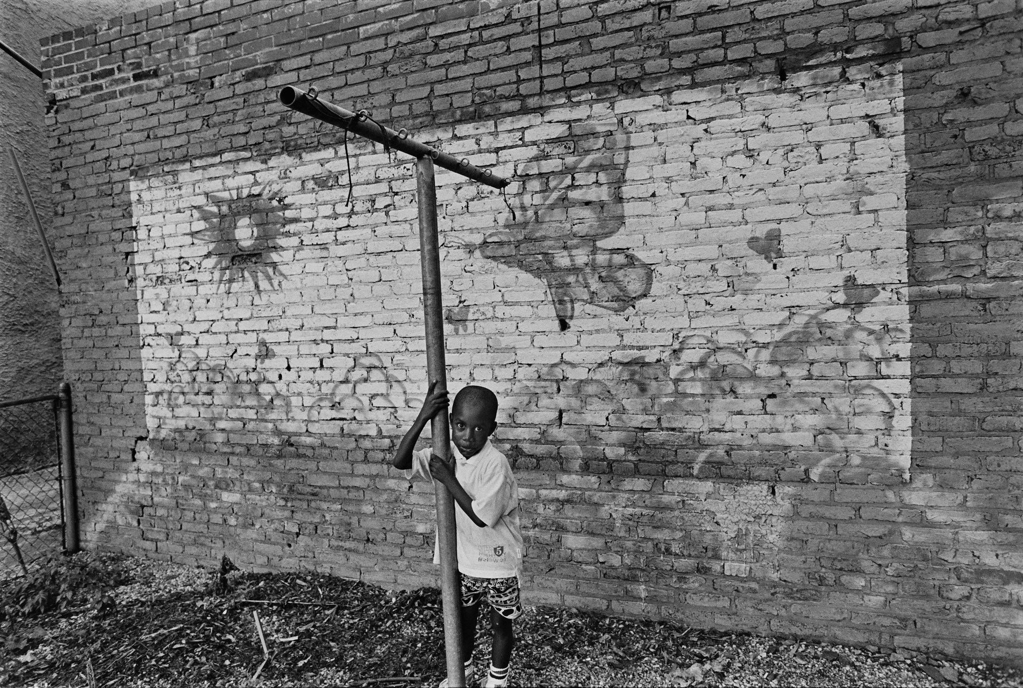 photograph of boy in front of butterfly mural in Baltimore City