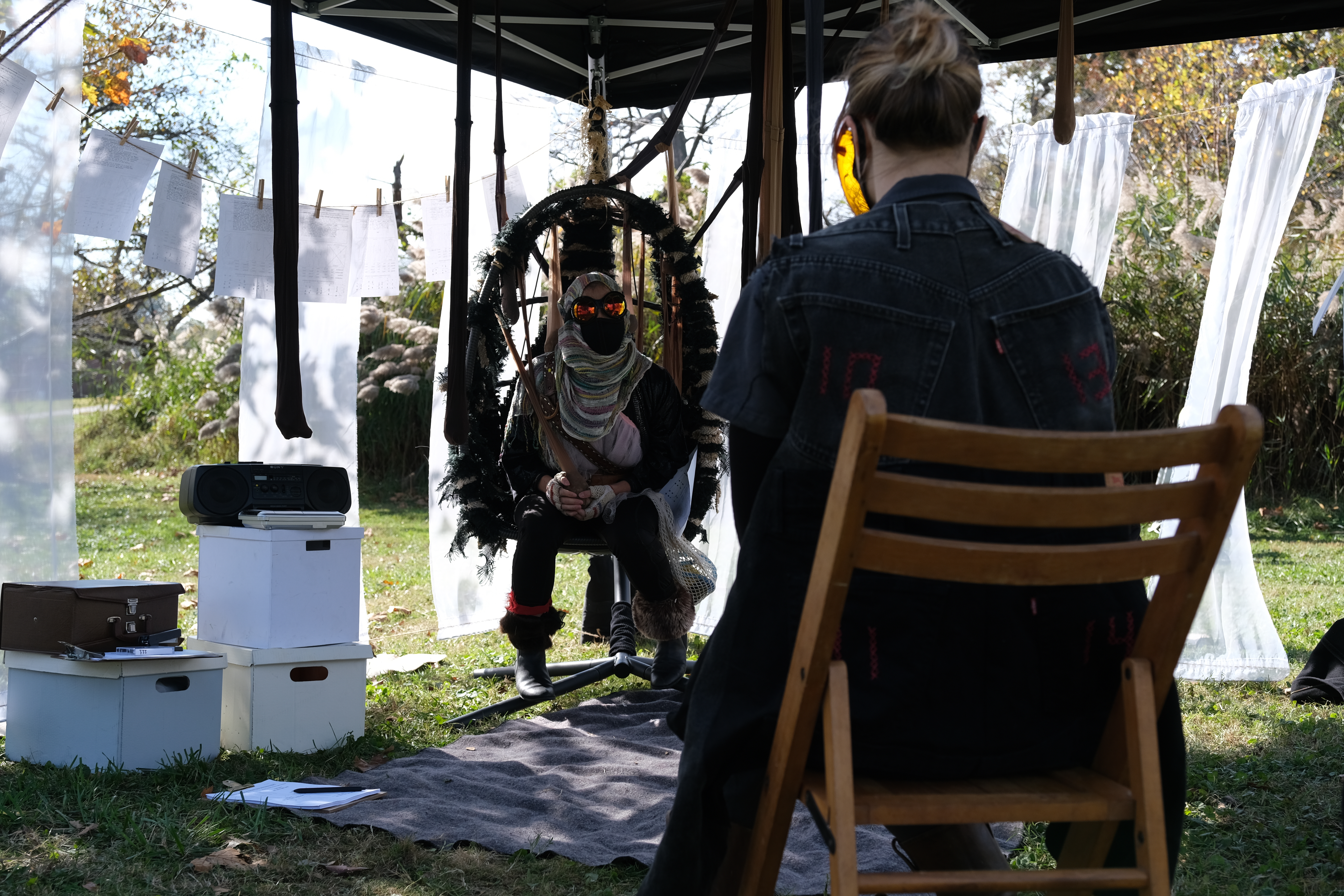 Performers Jessie Delaplaine and Martha Roubichaud using the Empathy Apparatus inside the Temporal Rift in the performance of rECHOllection in Druid Hill Park