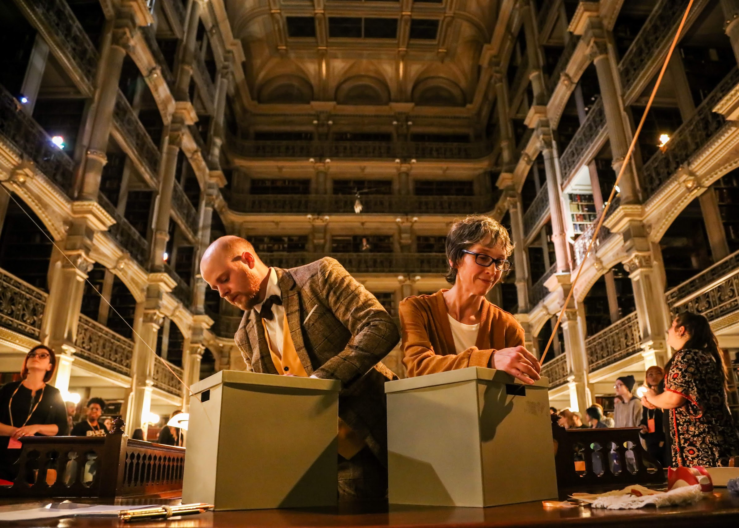See Also - performers David Brasington and Ursula Marcum rewind the connecting threads back into their archive boxes at the close of the show in the library