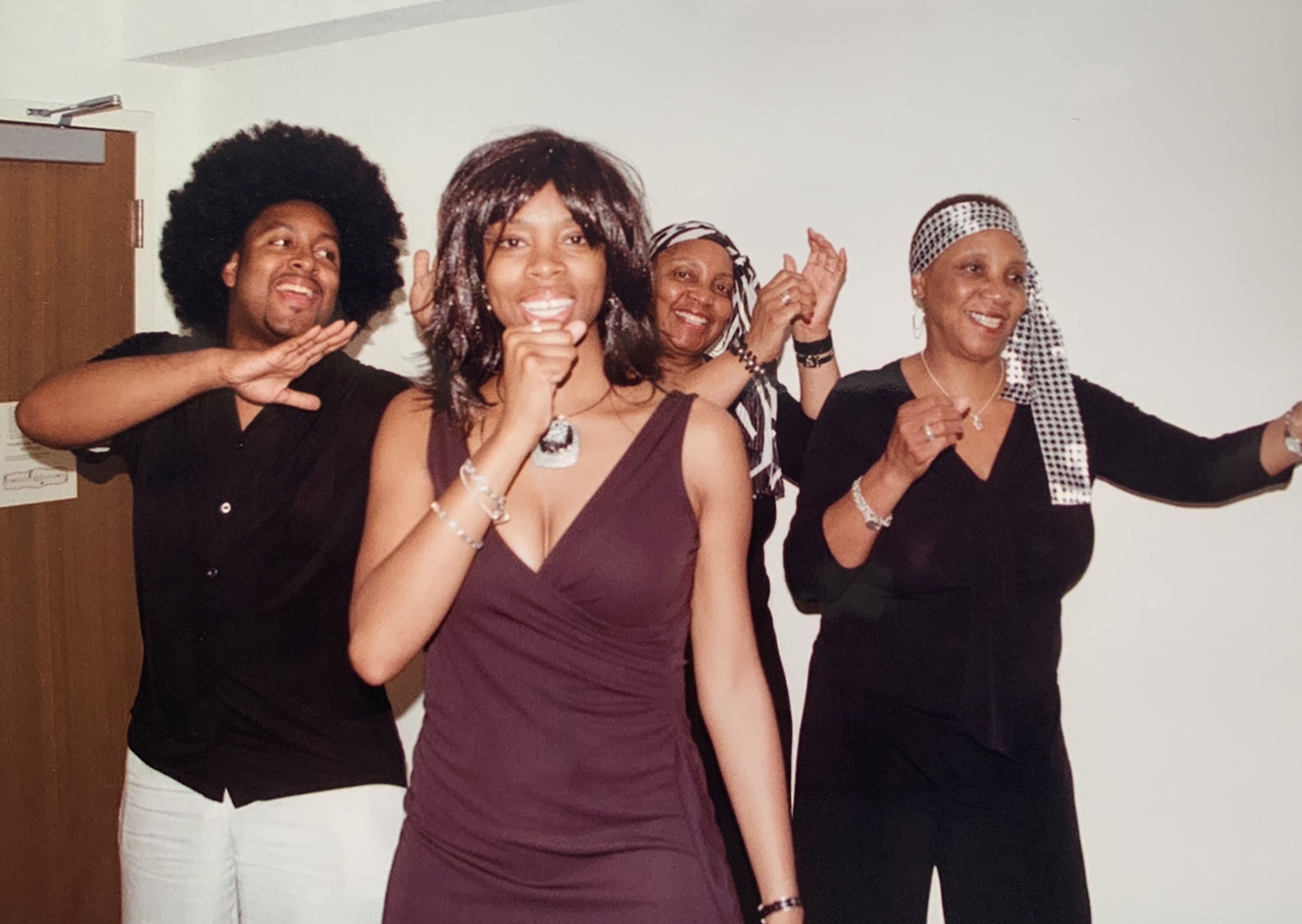 Four family members practicing a performance as Tina Turner, Ike and the Ikettes