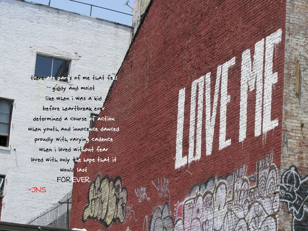 a photograph of the side of a building that has LOVE ME painted on it, taken by Jennifer N. Shannon