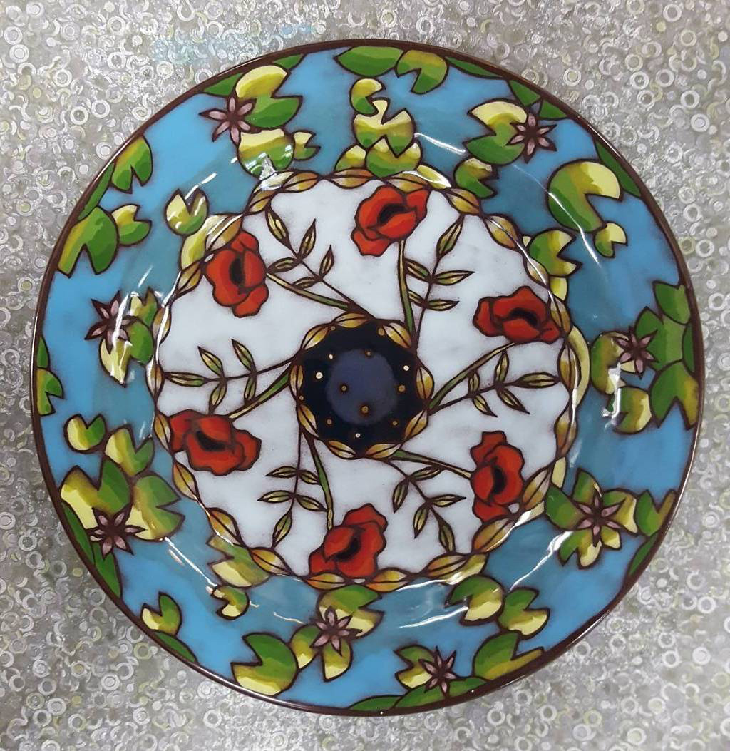 Plate with painted images of poppies, lilypads,  leaves, and a starry sky