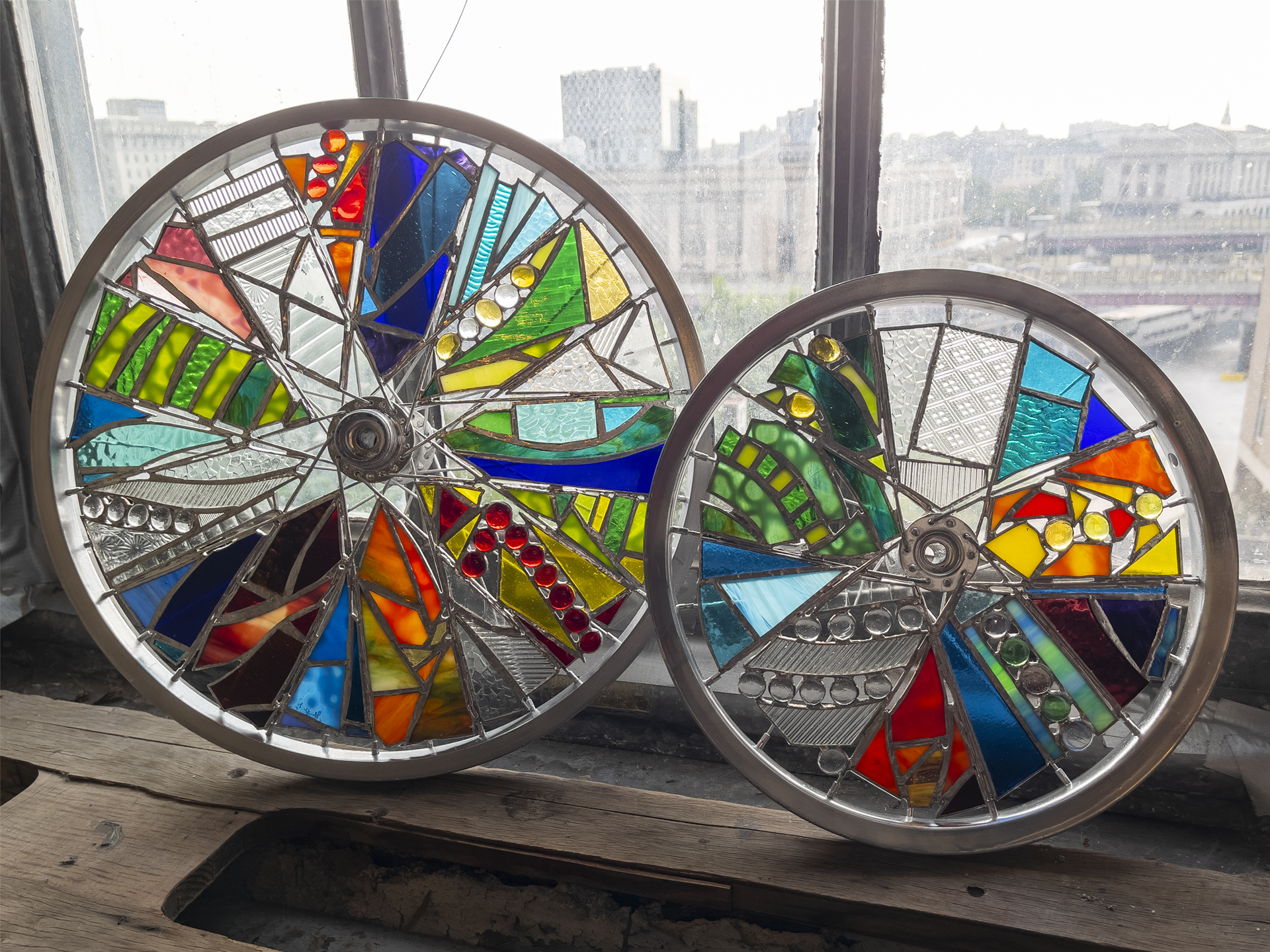 2 smaller abstract glass art wheels