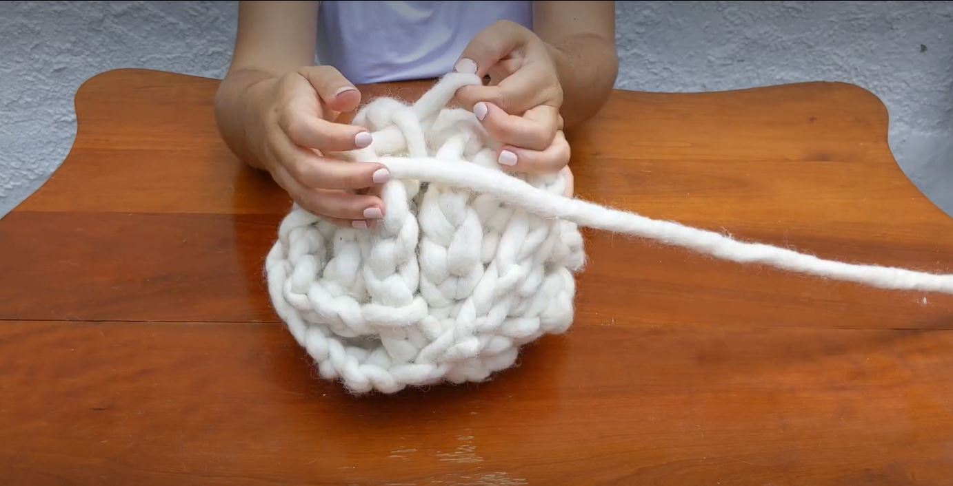 two hands tying knots