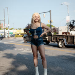 A woman poses for a portrait outside a restaurant in Pigtown.