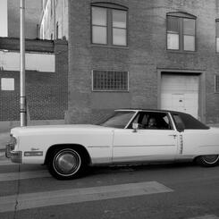 A man shows off his car in Pigtown.