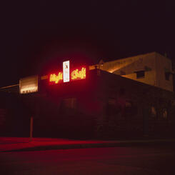 The neon light from an adult entertainment venue in the Canton Industrial Area.