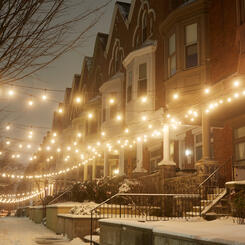 Snowy rowhomes with string lights on Linden Ave
