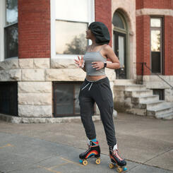 A young woman on roller skates on Reservoir Street.