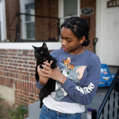 A young girl and her cat on Callow Ave