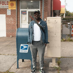 A man posing by the former laundromat at Linden and North Ave