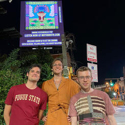 Moth Broth posing with our album release flyer on the LED billboard in Station North. 