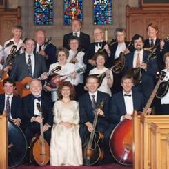 The Baltimore Mandolin Orchestra, 1999, with director David T. Evans (standing, center rear) and soprano Beatrice Gilbert (seated, front row, center)