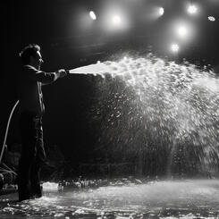 Tech Titan Directing a Firehose of Water at a TED Talk