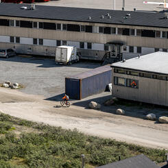Cyclist Passing Airport Terminal (2022)
