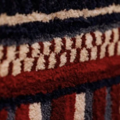 Detail, hand tufted rug, how stunningly beautiful that our sacred respect for earth, for life is deeper than our rage (Portrait of Salua Moussawel)