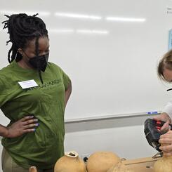 Trustina Teaching a Student How To Cut A Gourd Open At Arrowmont School of Arts and Crafts, July 2025