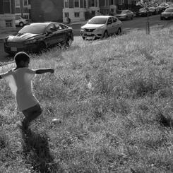 A kid playing in the field on Auchentoroly 