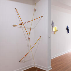 Locked stretch, 2025. latex tubing, silicone, hardware, dumbbell 90”x 40”x 8”
