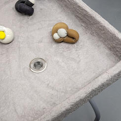 Play Party, 2018. Wood, concrete, latex, paper pulp, table legs.  35” x 24” x 30” 