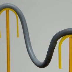 Gray rbbr Cane, 2022. Silicone rubber, wire, lucite  40” x 15” x 20”