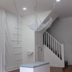 Sick Play: Body of a Trap, 2025. Chain, hardware, metal weights, silicone, 64”x42”x30”