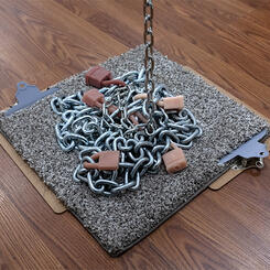 Chainlinked, (detail) 2025. Silicone, metal chain, carpet, spray paint, clipboards  16” x 16” x 168”