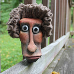 Carved and painted wooden head.