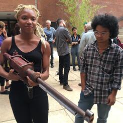 Woman holding gun sculpture