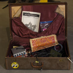 Suitcase with sound equipment and counter culture magazines.