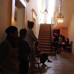 Eliza descending the stairs