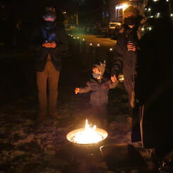 The Hong family warms up by one of the fires along the journey