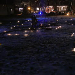 The shadows fire, at the center of the candlelit spiral