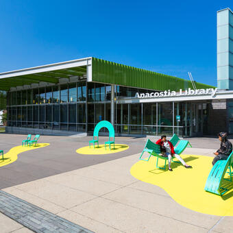 The Chairs sculptural seating public art installation in Washington DC. Each of the eight custom chairs and benches encourages interaction and offers unique opportunities for play and social engagement.