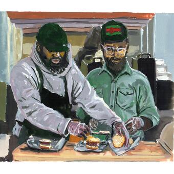 Two men prepare biscuits