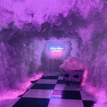 Immersive Installation that takes the form of a dry cleaner shop. The walls are entirely created with clear recycled plastic bags dry cleaning bags. They glow in a toxic pink and blue light which is shining from the shops neon sign on the wall 