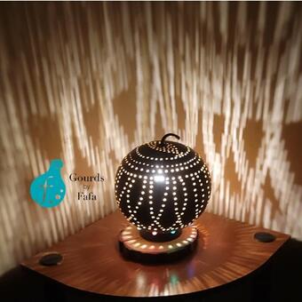 The lovely gourd lamp is one with bright energizing light shining through. It is a small lamp that gives bright light.