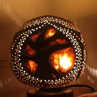 The Tree of Life  gourd lamp featured the three of life in three styles all around the gourd, with a fiery glow around each tree.