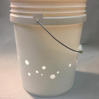 Purchased white 5 gallon construction bucket modified with holes of varying sizes along lower half, interior contains much smaller modeled version of purchased bucket