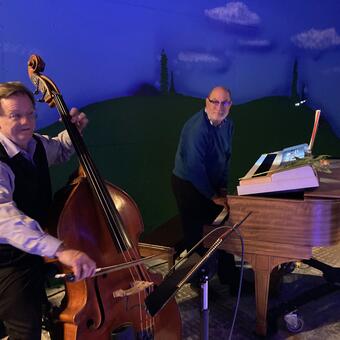 Dale Bohren on upright bass and Robert Hitz on piano and keyboard, on the set of A Midsummer Night’s Dream, where they created improvised music for the two-week run.