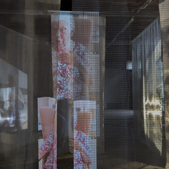 layers of fabric with projected images of people