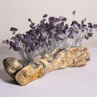 small piece of dry wood with wire and amethyst beads protruding upward