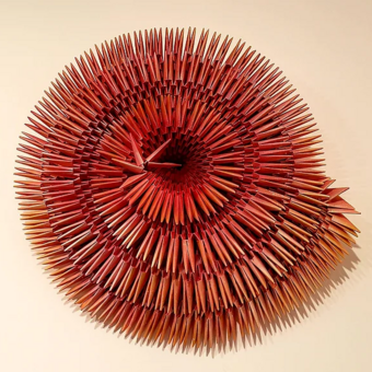 Folding countless pieces of paper as a means of quieting the mind through repetition