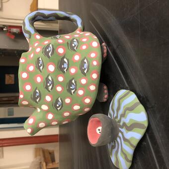 Wonky hand built teapot, matte exterior, clear glazed interior, with chrome green exterior, cute little feet, dots, eyes, and flippy toque top.