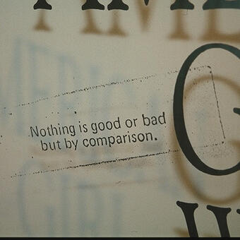 Partial view of a clear panel with black text on it. Photocopy of a fortune cookie reads: "In youth and beauty, wisdom is rare"